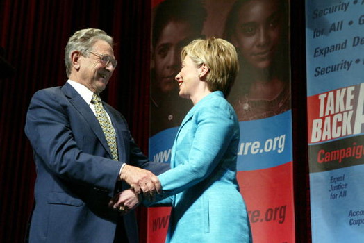 WASHINGTON - JUNE 3:  Philanthropist George Soros (L) greets U.S. Senator Hillary Clinton (D-NY) after she introduced him at the Take Back America Conference June 3, 2004 in Washington, DC. The conference aims to unite progressive issue groups as well as train for organizing campaigns in 2004 and beyond.  (Photo by Matthew Cavanaugh/Getty Images)
