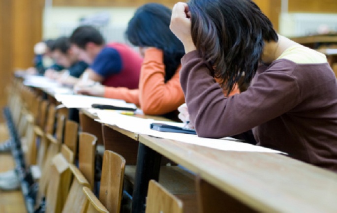 Student in class having an exam in school